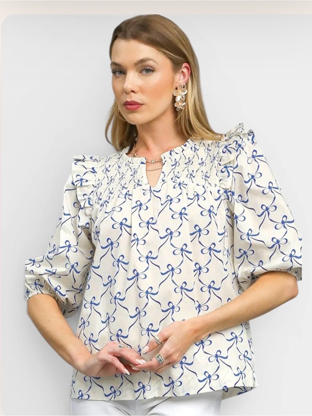 UMGEE Cream and Blue Boutique Blouse with Blue Bow Print and Ruffle Shoulders